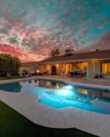 Lit pool and covered patio at dusk at a Desert Pine Stays home in Phoenix
